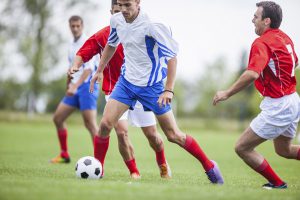 Soccer players during a match on football filed.